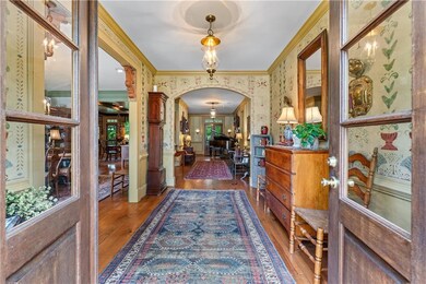Foyer featuring wallpapered walls, hardwood / wood