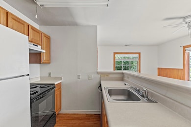 Kitchen with wood finished floors, freestanding r