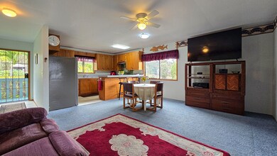 Spacious open-concept living, dining, and kitchen area with natural light and garden views.