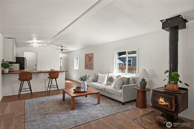Cozy up by the wood stove and settle into a move-in ready home that blends value, charm, and convenience!