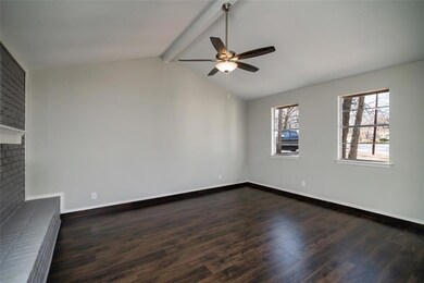 Living room has a vaulted ceiling, new floors and 