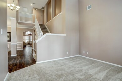 To the right of the entrance is a spacious and flexible area that can be used as a formal living room, library, office, or downstairs playroom if you have children.