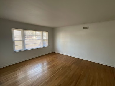 Spare room featuring wood-type flooring