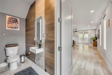 Bathroom with wooden walls, toilet, recessed ligh