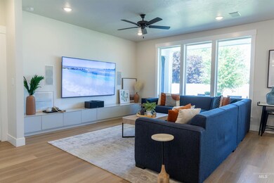 Living area featuring light wood-type flooring, a ceiling fan, and recessed lighting