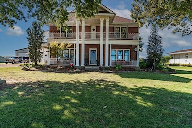 Greek revival house with a porch, a garage, and a 