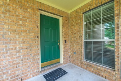 Charming brick entryway with a green front door an