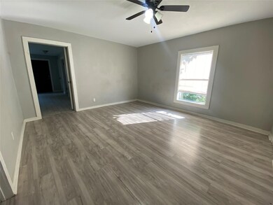 Unfurnished room with ceiling fan and hardwood / wood-style floors