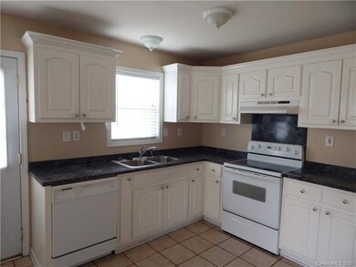 Kitchen is Open to Breakfast Area with Cheerful Wi