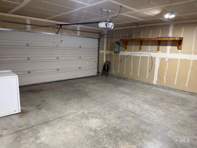 Garage featuring a garage door opener, washer / clothes dryer, and electric panel