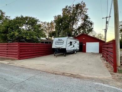 View of parking / parking lot featuring a garage