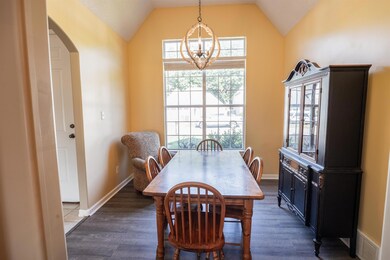 Dining space featuring dark wood-type flooring, lo