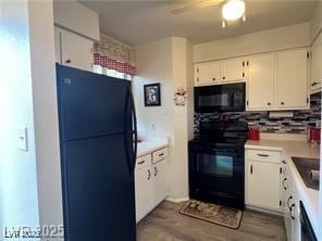 Kitchen featuring white cabinets, backsplash, wood