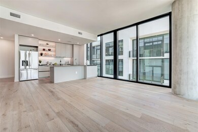 Unfurnished living room featuring a wall of windows and light wood finished floors