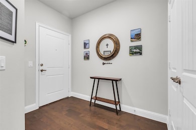 Foyer entrance with dark hardwood / wood-style flo