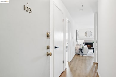 Hallway with light wood-type flooring and baseboards