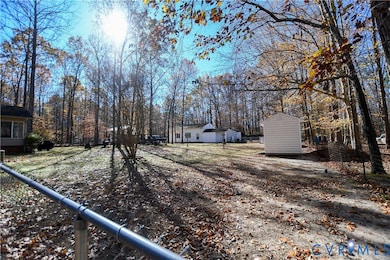 View of yard with a shed and view of scattered trees