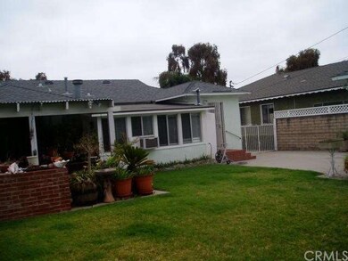 Rear view of home. Large lawn, nice landscaping, c