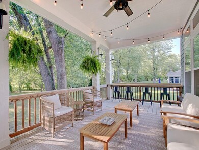 Covered back porch overlooking quiet backyard offers ideal spot for reading, relaxing or entertaining
