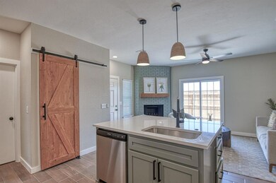 Kitchen featuring gray cabinets, an island with si