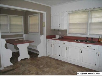 Kitchen with eat in nook offers table and benches already for you!