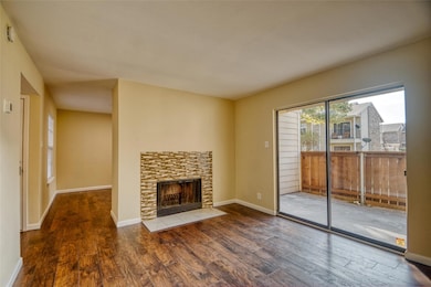 Unfurnished living room with a stone fireplace and