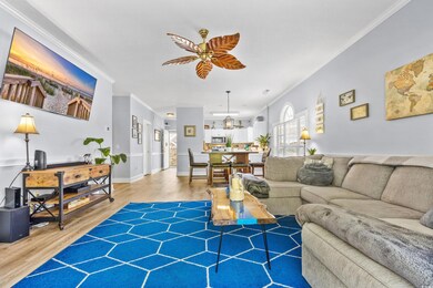 Living area featuring crown molding, ceiling fan, 