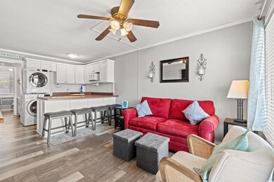 Living room featuring stacked washer / drying mach