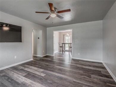 Living room with new flooring, natural light, and 