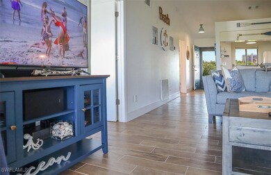 Living room featuring visible vents and wood finis