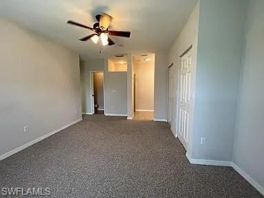 Unfurnished bedroom with carpet flooring, baseboar
