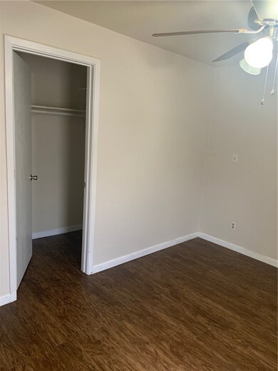 Unfurnished bedroom with ceiling fan, a closet, ba