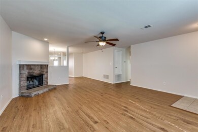 Living room with light hardwood / wood-style floor