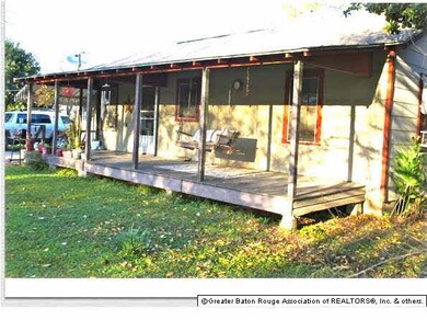 Large, covered back porch. Swing remains.