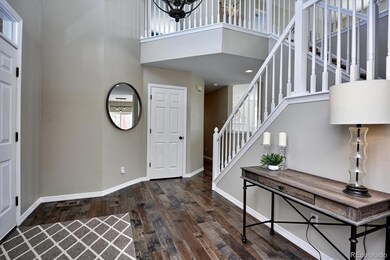 Vaulted entry, hardwood flooring
