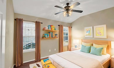 Bedroom with lofted ceiling, a ceiling fan, and w