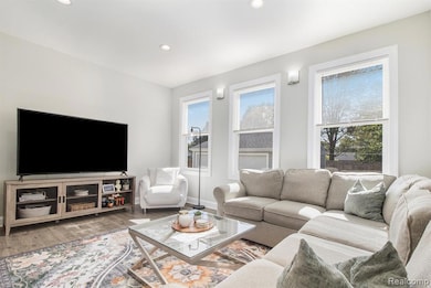 Living area with wood finished floors and recessed lighting