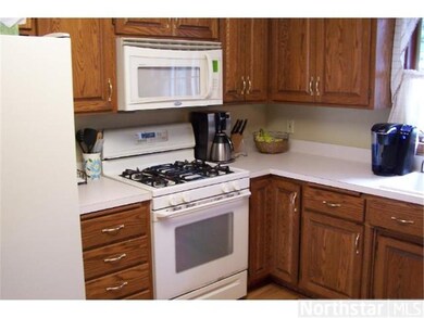 Kitchen has oak wood floors.