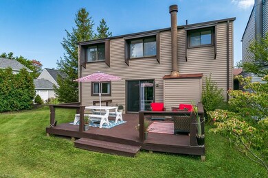 Rear view of house featuring a yard and a deck