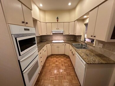 Kitchen featuring white dishwasher, light parquet 
