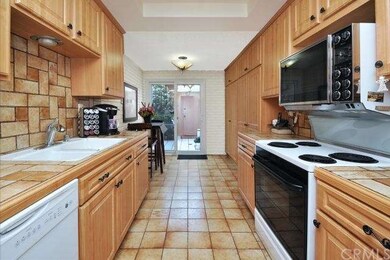 Kitchen with custom tiles on floor and backsplash
