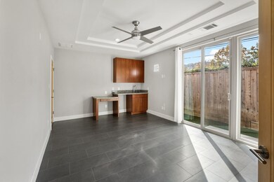 First floor Bedroom with cabinetry, sink and table
