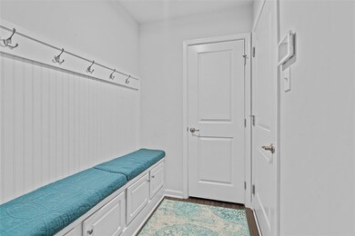 Built-in bench area next to garage and laundry roo