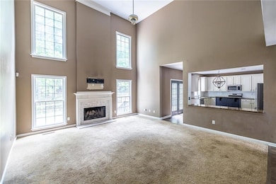 View into the kitchen with a spacious bar for ente
