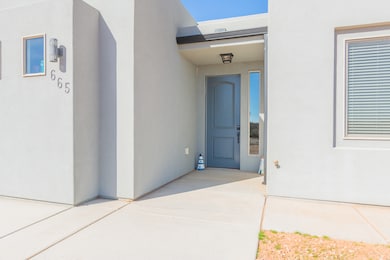 View of exterior entry featuring stucco siding