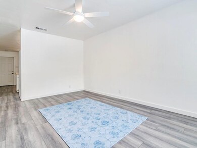 Unfurnished room featuring visible vents, baseboa