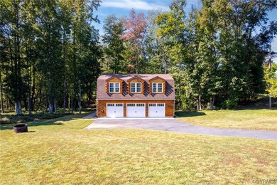 View of front of house with a garage and a front y