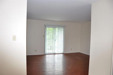 Spare room with wood finished floors and baseboar