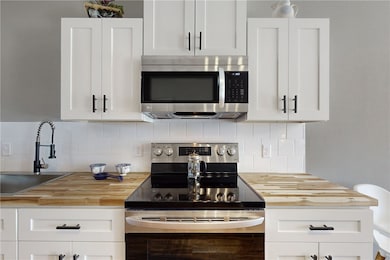 Kitchen with stainless steel appliances, butcher b