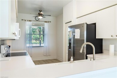 Kitchen featuring a ceiling fan, light countertops